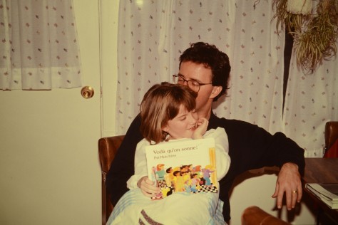 My father giving me a kiss while we were reading a book together before my bed time.